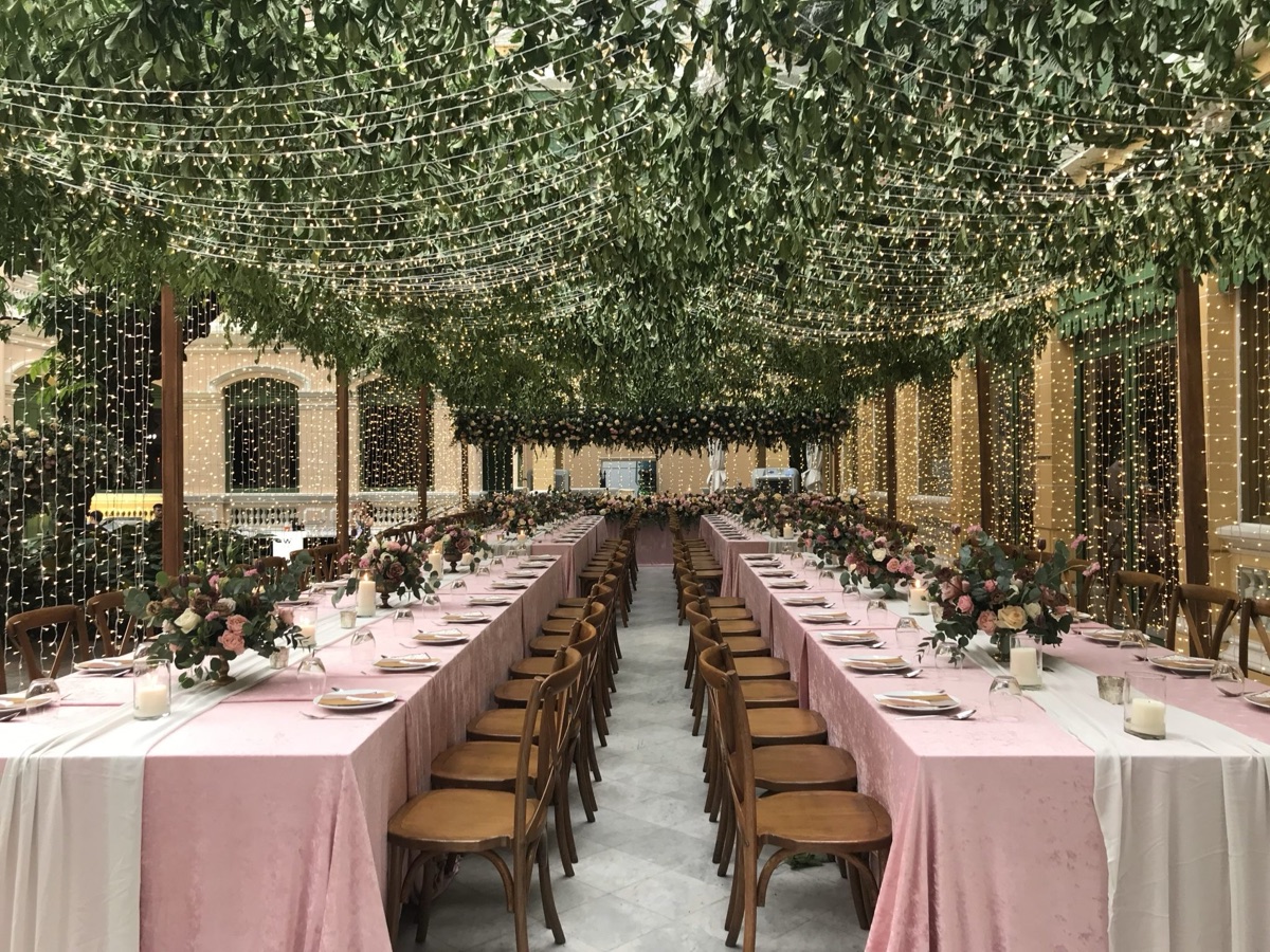 Long family table set for a walima lunch with matching chairs and runners