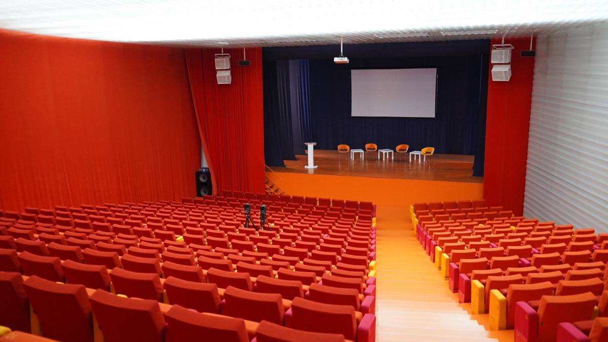 Corporate event management in Hyderabad: annual day in a Hitec City hall with a lit stage and seated employees