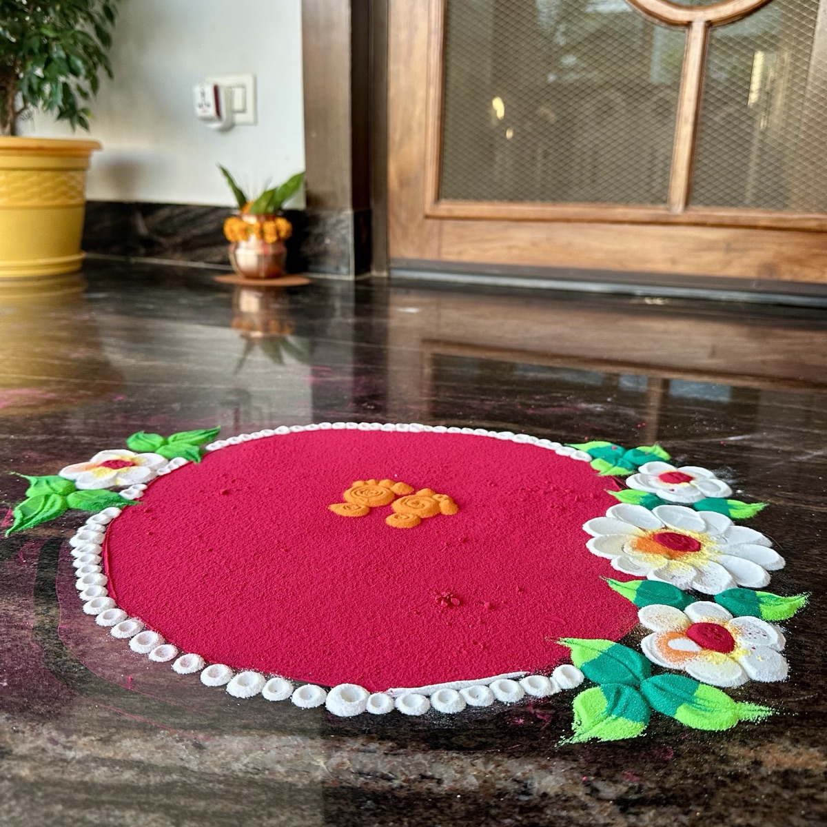Griha pravesham doorway with mango-leaf toran, rangoli and a decorated entrance