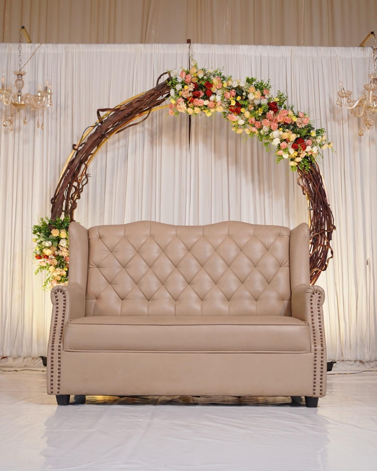 Nikah stage with a white floral drape and seated family in a Hyderabad function hall