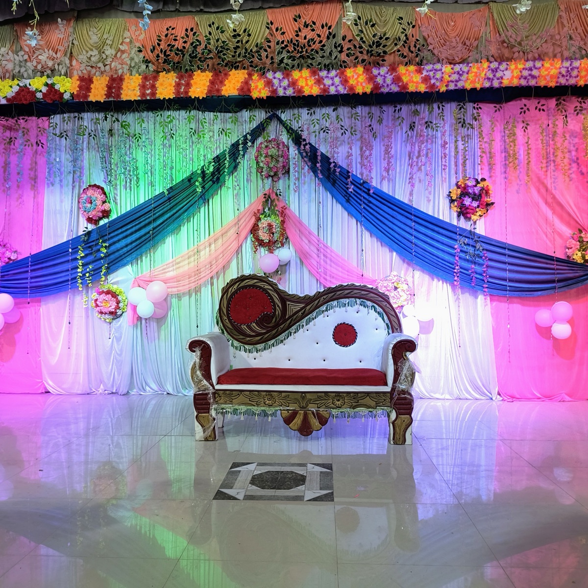 Sangeet night with a lit dance floor and stage