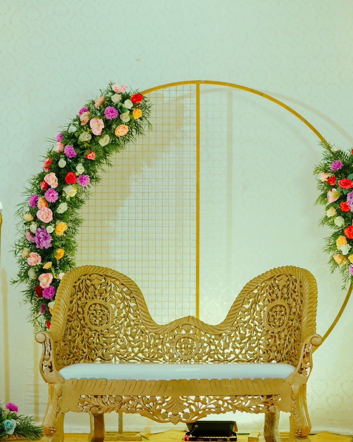 Nikah stage with floral drape and seated family before the ceremony in a Hyderabad function hall