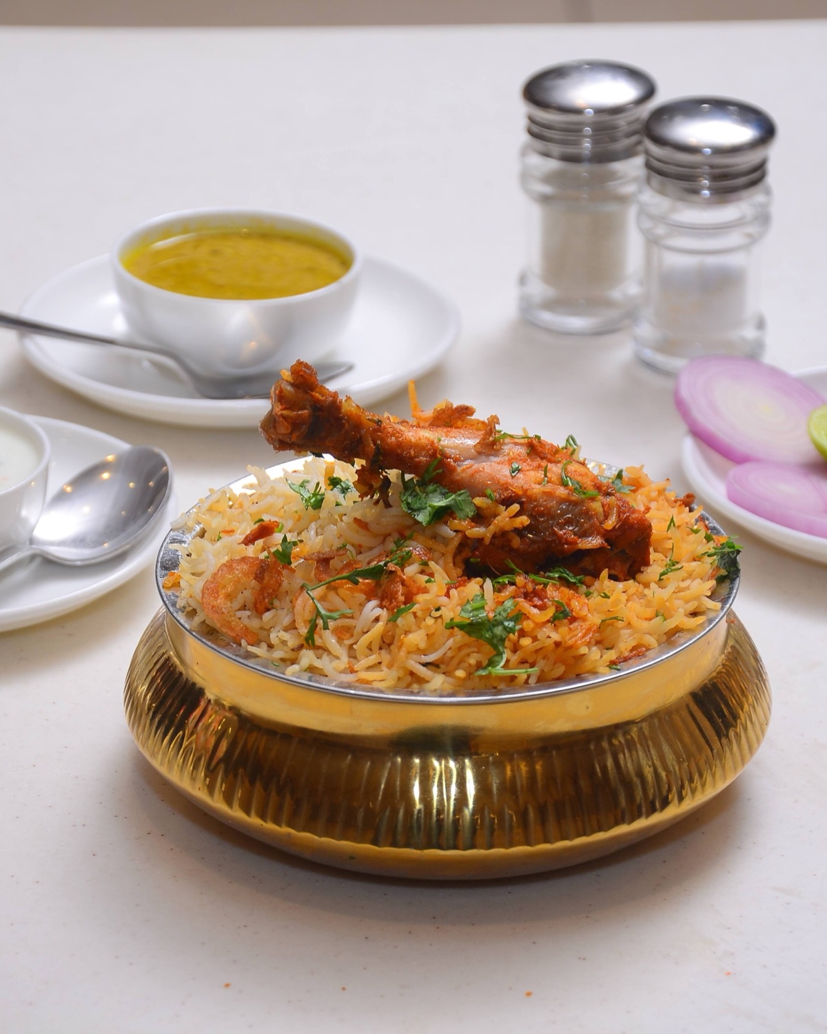 Table spread of biryani, kebabs and curries at Mubarak Restaurant Medchal